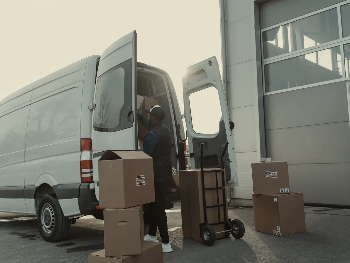 High roof van with rear doors open at a loading bay