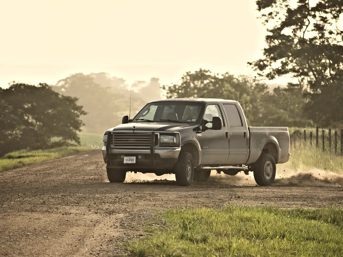 Crew cab light duty truck in three quarter view on a gravel track