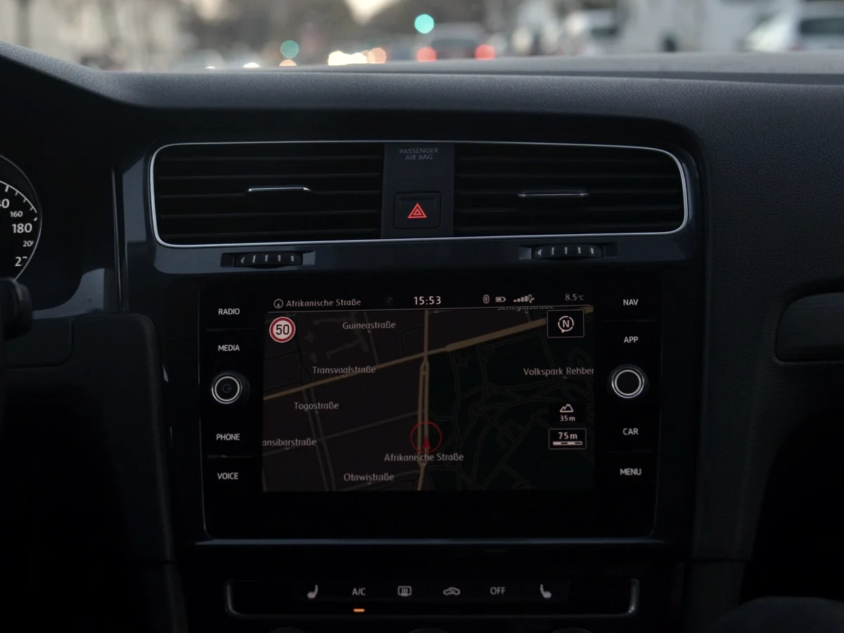In-dash navigation screen showing a planned route through city streets at night